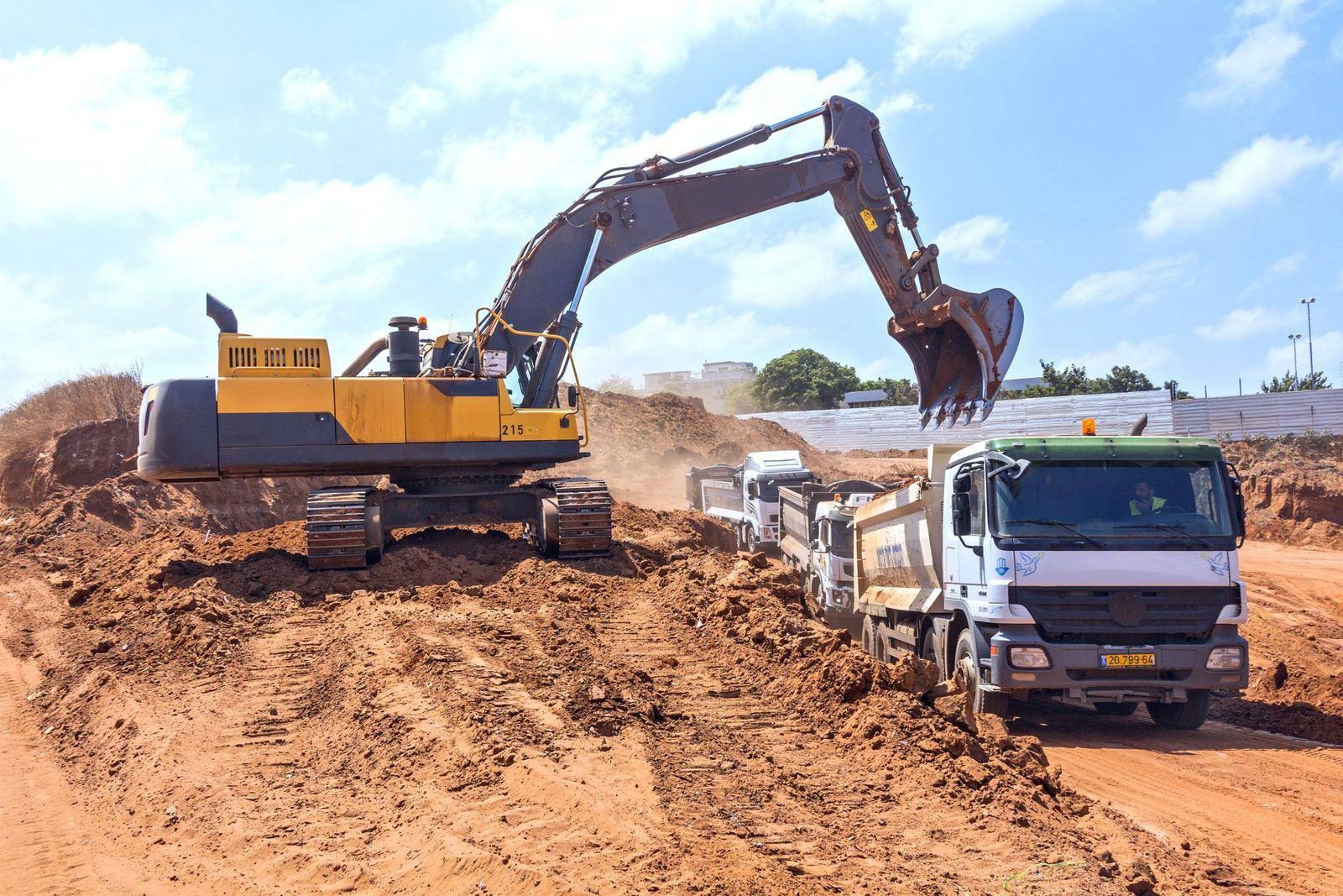 Excavator loading a dump truck at a construction site